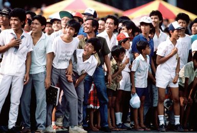 Enthusiastic Indonesian spectators watch a performance by the US Air Force Thunderbirds flight demonstration team. The Thunderbirds are performing in Indonesia as part of their 1987 Pacific tour which encompasses nine countries and Guam