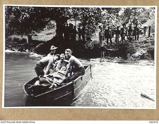 GODOWA, NEW GUINEA. 1943-11-05. TRANSPORT PROBLEMS ARE OVERCOME IN THE AREA BY THE USE OF A CAPTURED JAPANESE PONTOON TO TRANSPORT WOUNDED PERSONNEL FROM THE 2/3RD AUSTRALIAN CASUALTY CLEARING ..