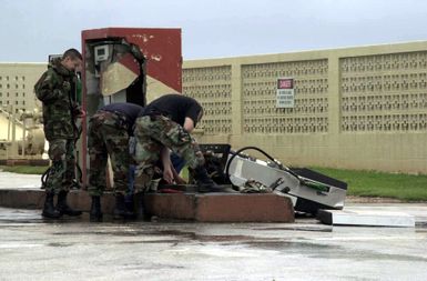 US Air Force (USAF) Airmen from the 36th Civil Engineer Squadron (CES) work on repairing a downed gas pump as a result of super-typhoon Pongsona Sunday December 8th at Andersen Air Force Base (AFB), Guam