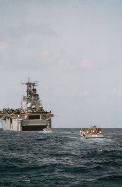 Two LCM-8 mechanized landing craft move toward the open well deck of the amphibious assault ship USS SAIPAN (LHA 2) during Operation Sharp Edge. Marines embarked aboard the SAIPAN are being sent to the U.S. Embassy in Monrovia, Liberia, to augment security and evacuate U.S. and foreign nationals from the fighting between government and rebel forces