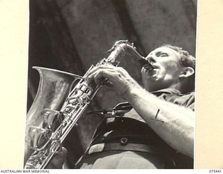 MILILAT, NEW GUINEA. 1944-08-23. TX14939 CORPORAL E.S.T. SAUNDERS, THE SAXOPHONIST OF THE "TASMANIACS" THE TASMANIAN LINES OF COMMUNICATION CONCERT PARTY PRACTISING DURING A CONCERT REHEARSAL