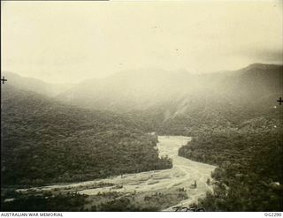 NORTH EAST NEW GUINEA. 1945-03-09. HEAVY RAIN CLOUDS HOVER OVER THE TORRICELLI MOUNTAINS OF NORTH EAST NEW GUINEA. IN THE FOREGROUND, WATERWAYS SPREAD OUT OVER AN AREA OF FLAT COUNTRY. IT IS OVER ..