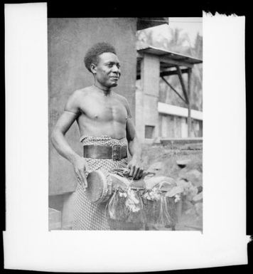 Man playing a fringed drum, New Guinea, ca. 1936 / Sarah Chinnery
