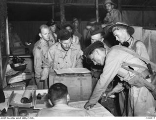 VIVIGANI, GOODENOUGH ISLAND, PAPUA. 1943-10-12. AUSTRALIAN BEAUFORT AIRCRAFT OF NO. 8 SQUADRON RAAF TOOK PART IN THE AIR ATTACK ON RABAUL. AN AIRCRAFT CAPTAIN POINTS OUT TO THE INTELLIGENCE OFFICER ..