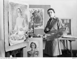 MELBOURNE, VIC. 1945-01-09. CAPTAIN NORA HEYSEN, OFFICIAL WAR ARTIST, MILITARY HISTORY SECTION, IN HER STUDIO AT 138 FLINDERS STREET COMPLETING PAINTINGS WHICH WERE COMMENCED IN NEW GUINEA