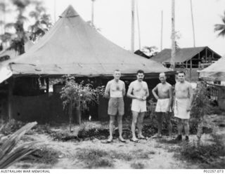 Madang, New Guinea, 1945-08. Informal outdoors portrait of four bare-chested officers serving with Headquarters, RAAF Northern Command (NORCOM). The men are (left to right): Flight Lieutenant (Flt ..