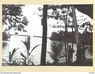 SIAR, NEW GUINEA. 1944-06-28. LOOKING OUT TO SEE FROM HEADQUARTERS, 15TH INFANTRY BRIGADE. IDENTIFIED PERSONNEL ARE:- VX139884 CORPORAL A.M. JENKINS (1); VX89731 CORPORAL S.R. CHENERY (2); B3/99 MR ..