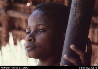 A Bogaia boy staring out of his house into the forest of the Nali Valley