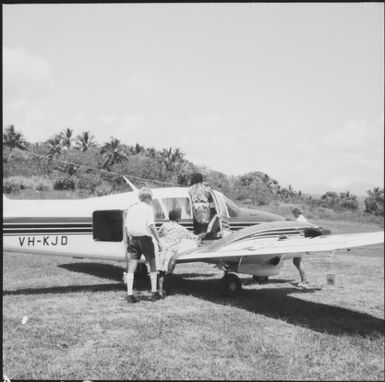 Passengers embarking on a small plane, Port Vila, Vanuatu, approximately 1969 / Michael Terry