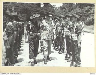 TOROKINA, BOUGAINVILLE. 1945-03-30. LORD WAKEHURST, GOVERNOR OF NEW SOUTH WALES (2), ACCOMPANIED BY MAJOR W. MCCALL, GUARD COMMANDER, 57/60 INFANTRY BATTALION (1), INSPECTING A GUARD OF HONOUR AT ..