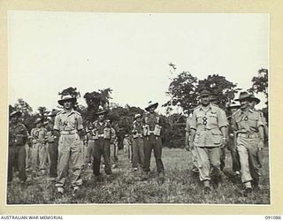 LAE AREA, NEW GUINEA. 1945-04-25. MAJOR-GENERAL C. H. SIMPSON, SIGNAL OFFICER-IN-CHIEF (8), MOVING TOWARDS THE DAIS FOLLOWING AN INSPECTION OF 19 LINES OF COMMUNICATION SIGNALS PERSONNEL, DURING A ..
