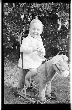 Margaret Hare sitting on a push along toy donkey