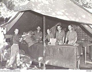 RABAUL, NEW BRITAIN, 1945-12-06. MEMBERS OF 11 DIVISION POSTAL UNIT WORKING AT A FIELD POST OFFICE