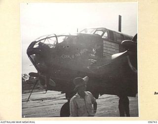 WEWAK AIRSTRIP, NEW GUINEA, 1945-09-17. SHOT SHOWING A SKETCH OF COCK ROBIN PAINTED ON A BEAUFORT BOMBER PARKED ON THE AIRSTRIP