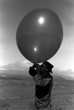 Lance Corporal Boan inflates a weather balloon at the Pakalula Training Area. The balloon is being used to determine wind conditions during Operation ZULU WARRIOR