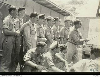 KIRIWINA, TROBRIAND ISLANDS, PAPUA. C. 1943-11. AIRCREWS OF NO. 22 (BOSTON) SQUADRON RAAF, BEING BRIEFED FOR AN AIR ATTACK ON NEW BRITAIN. LEFT TO RIGHT: PILOT OFFICER (PO) J. K. LEWIS; FLYING ..