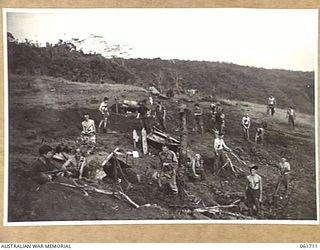 WAREO, NEW GUINEA. 1943-12-09. TROOPS OF THE 2/23RD AUSTRALIAN INFANTRY BATTALION DIGGING IN AFTER THE CAPTURE OF THE AREA. IDENTIFIED PERSONNEL ARE: VX51630 PRIVATE J. R. MELROSE (1) VX45759 ..