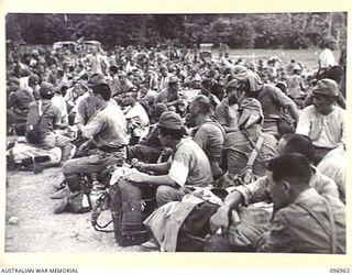 TOROKINA, BOUGAINVILLE. 1945-09-23. JAPANESE NAVAL TROOPS ON A 10-MILE MARCH FROM THE BUKA AREA ESCORTED BY TROOPS OF 27 INFANTRY BATTALION, WERE GIVEN A WELCOME REST AT THE GLOUCESTER PARK OVAL. ..