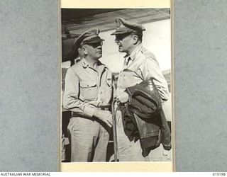 1943-07-07. NEW GUINEA. PACIFIC OFFENSIVE. GENERAL DOUGLAS MACARTHUR WHO IS COMMAND OF THE ALLIED OFFENSIVES IN NEW GUINEA AND THE SOLOMONS, PHOTOGRAPHED BESIDE HIS PLANE IN NEW GUINEA. WITH HIM IS ..