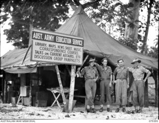 MALMAL VILLAGE, NEW BRITAIN. 27 FEBRUARY 1945. THE EDUCATION OFFICER AND MEMBERS OF HIS STAFF AT HEADQUARTERS, 5TH DIVISION. IDENTIFIED PERSONNEL ARE:- NX140609 CAPTAIN A.W. JOHN (1); VX30255 ..