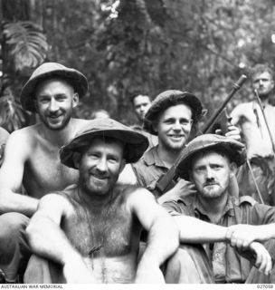 PAPUA, NEW GUINEA. 1942-10. A HAPPY GROUP OF FOUR BEARDED SOLDIERS OF THE 2/31ST AUSTRALIAN INFANTRY BATTALION ON THE TRACK ACROSS THE OWEN STANLEY RANGES BETWEEN NAURO AND MENARI. THEY HAVE NOT ..