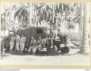 MILILAT, NEW GUINEA. 1944-09-15. RADIO PERSONNEL OF THE UNITED STATES ARMY GENERAL HEADQUARTERS DETACHMENT ATTACHED TO HEADQUARTERS, 5TH DIVISION, STANDING BESIDE ONE OF THE UNIT VEHICLES. ..