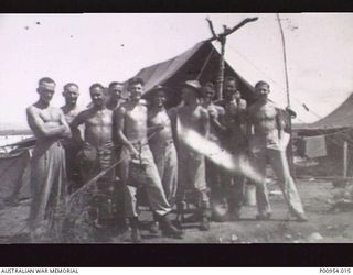 BIAK, NEW GUINEA. 1944-03. UNIT NO 1 WIRELESS UNIT RAAF. JAPANESE KANA WIRELESS INTERCEPT OPERATORS AND CYPHER AND CODE BREAKERS IN FRONT OF TENTS. FAR RIGHT:- JAPANESE KANA WIRELESS INTERCEPT ..