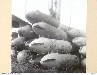 HANSA BAY, NEW GUINEA. 1944-07-10. DURALIUM AIRCRAFT BELLY TANKS ABANDONED BY RETREATING JAPANESE FORCES ARE SALVAGED BY 5TH DIVISION SALVAGE GROUP FOR THE RAAF