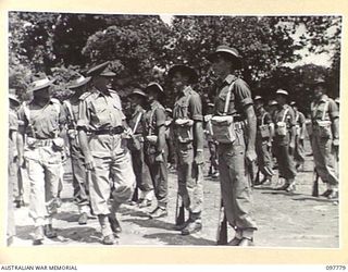 NAMANULA, NEW BRITAIN. 1945-10-08. MEMBERS OF 11 DIVISION SIGNALS ON PARADE. THEY ARE BEING INSPECTED BY MAJOR GENERAL K.W. EATHER, GENERAL OFFICER COMMANDING 11 DIVISION, WHO IS ACCOMPANIED BY ..