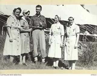 EGGY'S CORNER, PORT MORESBY AREA, PAPUA, 1944-02-20. MEMBERS OF THE STAFF OF WARD 14 OUTSIDE THE WARD AT THE 2/1ST GENERAL HOSPITAL. IDENTIFIED PERSONNEL ARE: PRIVATE ELLA WHITE, AUSTRALIAN ARMY ..