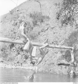 ZENAG, NEW GUINEA, 1944-02-27. QX44283 SAPPER W. VOEVODIN (1), WINNER OF THE OPEN FREESTYLE, ENGAGES NX172145 SAPPER F.J. DELANDER (2), (THE RUNNER UP), IN A GREASY POLE FIGHT USING SANDBAGS FILLED ..