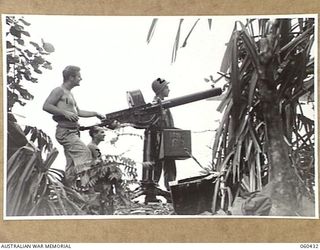 GODOWA, NEW GUINEA. 1943-11-05. A 50 CALIBRE MACHINE GUN AND CREW OF THE UNITED STATES 102ND COAST ARTILLERY BATTALION IN A PICTURESQUE SETTING ON THE BEACH. SHOWN ARE: PRIVATE W. T. BOWERS OF NEW ..