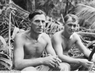 MILNE BAY, NEW GUINEA. 1943-06-30. SX12905 SAPPER L. KRISTOFFERSEN (LEFT) AND NX84188 CORPORAL W. COX OF THE 2/3RD AUSTRALIAN DOCKS OPERATING COMPANY, ROYAL AUSTRALIAN ENGINEERS, TAKING A REST ..