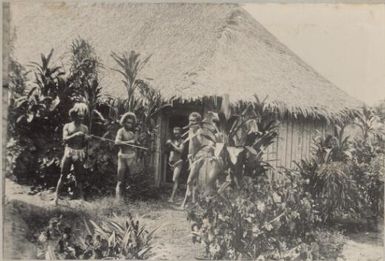 Five men with weapons outside a hut, Solomon Islands, approximately 1895