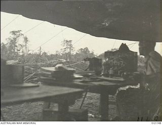 NADZAB, NEW GUINEA. 1944-05-09. A MEMBER OF THE RAAF LOOKS OUT FROM THE DUTY PILOTS TOWER AT THE AIRFIELD