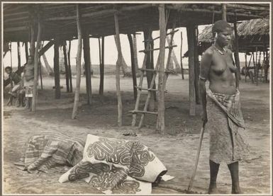 Funeral ceremony, Wanigella [Wanigela], [a woman standing in front of a body covered by cloth] Frank Hurley