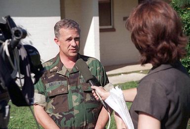 Major Steve Andrews, Officer in Charge of the Civil Affairs office, Tiyan, Guam, is interviewed by a local television station concerning the Guam Department of Educations donation of desks, chairs, and classroom materials to the school on Tiyan for the Kurdish evacuee children during Operation PACIFIC HAVEN. PACIFIC HAVEN provided Kurdish evacuees political asylum from Iraq. While on Guam, the Kurds are provided shelter, food, clothing, medical care and assimilation classes for life in the United States