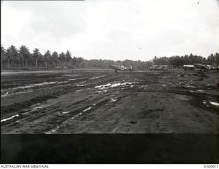 MILNE BAY, PAPUA. C. 1942-10. KITTYHAWK AIRCRAFT OF NO. 75 SQUADRON RAAF WAITING FOR A BEAUFIGHTER AIRCRAFT OF NO. 30 SQUADRON RAAF TO LAND BEFORE TAKING OFF FROM THE MUDDY GURNEY AIRSTRIP