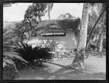 Unidentified RNZAF men outside a hut at a hotel, Rarotonga, Cook Islands