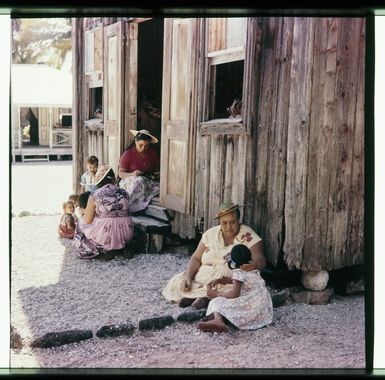 Women and children sitting on the steps outside the Church of Zion on Palmerston Islet