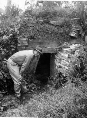 U.S. Reparations Mission Team Member Examines Japanese Dugouts, Guam Island, Pacific