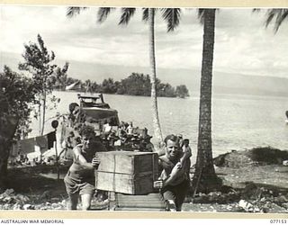 JACQUINOT BAY, NEW BRITAIN. 1944-11-20. PERSONNEL OF THE ARMY CANTEEN SERVICES BULK STORE NO. 6 GETTING SUPPLIES FROM THE BEACH TO THE UNIT STORE IN THE PALMALMAL PLANTATION. IDENTIFIED PERSONNEL ..