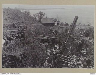 WEWAK POINT, NEW GUINEA, 1945-05-17. A JAPANESE 75 MILLIMETRE ANTI-AIRCRAFT GUN DESTROYED BY THE ROYAL AUSTRALIAN AIR FORCE. THE AREA IS NOW OCCUPIED BY 2/2 FIELD REGIMENT, ROYAL AUSTRALIAN ARMY ..