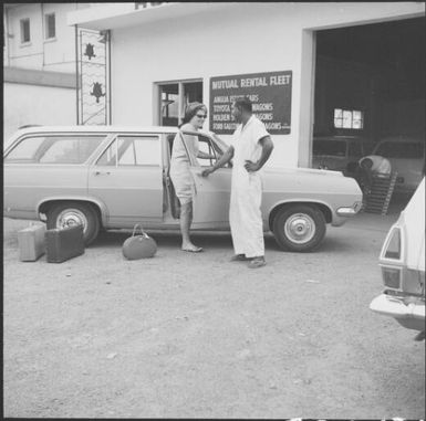 Woman getting into a rental car from Mutual Rental Fleet, Fiji, 1966, 1 / Michael Terry