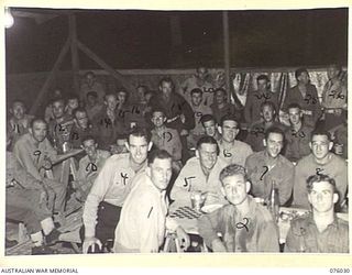 MADANG, NEW GUINEA. 1944-09-16. COMPETITORS IN THE BOXING AND WRESTLING TOURNAMENT HELD AT THE 165TH GENERAL TRANSPORT COMPANY BEING ENTERTAINED IN THE SERGEANT'S MESS AFTER THE SHOW