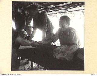 KARAWOP, NEW GUINEA, 1945-09-18. LIEUTENANT G.D. GRIFFIN, UNIT PAYMASTER, 2/6 CAVALRY COMMANDO REGIMENT EDUCTION SECTION