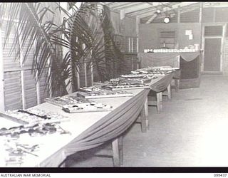 LAE, NEW GUINEA, 1945-12-15. A SECTION OF THE SUPPER TABLES ARRANGED FOR THE CHRISTMAS DANCE AT AUSTRALIAN NEW GUINEA ADMINISTRATIVE UNIT HEADQUARTERS