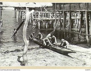 PORT MORESBY, PAPUA. 1942-07-20. THE ARMY'S "NAVY"- A PRIMITIVE BUT EFFECTIVE WAY OF PATROLLING THE BEACHES. THESE AUSTRALIAN INFANTRYMEN ARE RETURNING FROM A PATROL IN A NATIVE CANOE. ONE MAN MAY ..