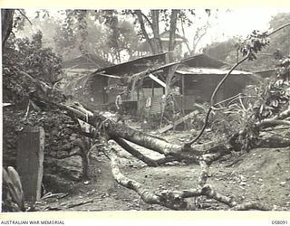 KAKAKOG AREA, NEW GUINEA, 1943-10-02. RUINED BUILDINGS AND TREES IN BOMB DAMAGED AREA