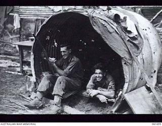 WAREO, NEW GUINEA. 1943-12-09. VX35138 PRIVATE (PTE) A. HIRST OF LANCEFIELD, VIC (1) AND SX7022 PTE R. C. POYNTER OF SEMAPHORE, SA (2); BOTH OF THE 2/23RD AUSTRALIAN INFANTRY BATTALION IN THEIR NEW ..